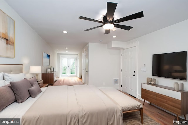 bedroom with light hardwood / wood-style flooring, french doors, and ceiling fan