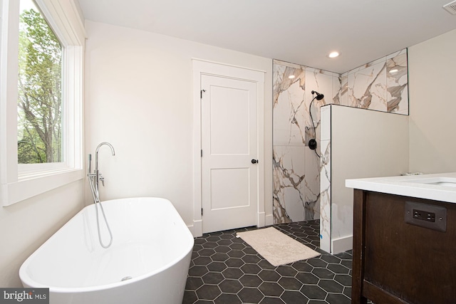 bathroom with vanity, shower with separate bathtub, and tile patterned flooring