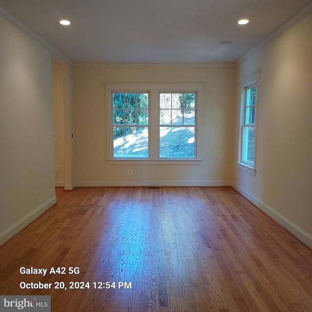 unfurnished room with light hardwood / wood-style flooring and ornamental molding