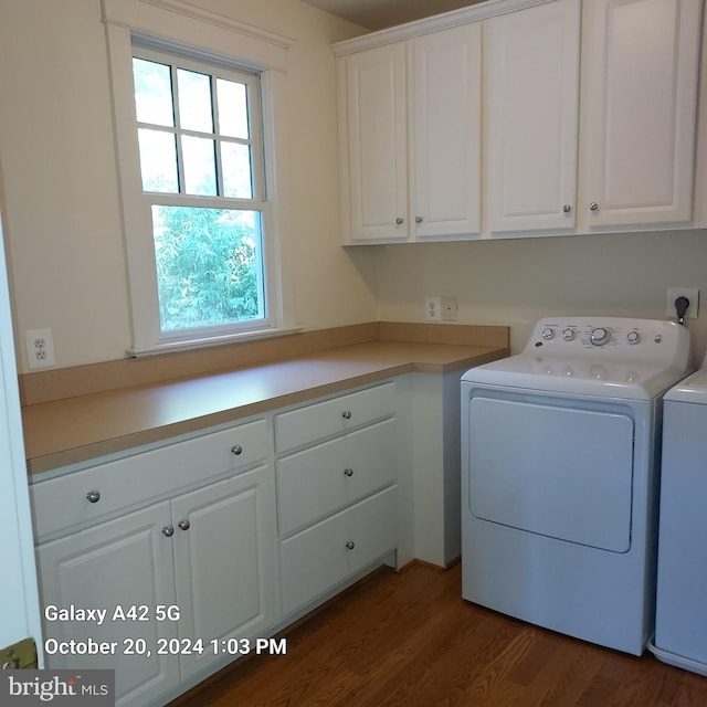 clothes washing area with dark wood-type flooring, independent washer and dryer, and cabinets