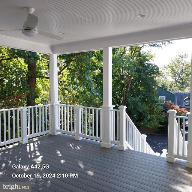 wooden deck featuring ceiling fan