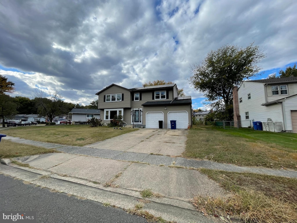 front of property featuring a garage and a front lawn