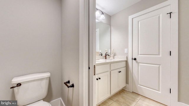 bathroom with tile patterned floors, vanity, and toilet