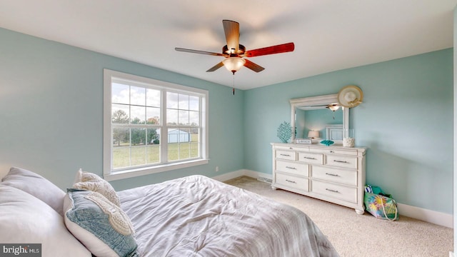 bedroom featuring light colored carpet and ceiling fan