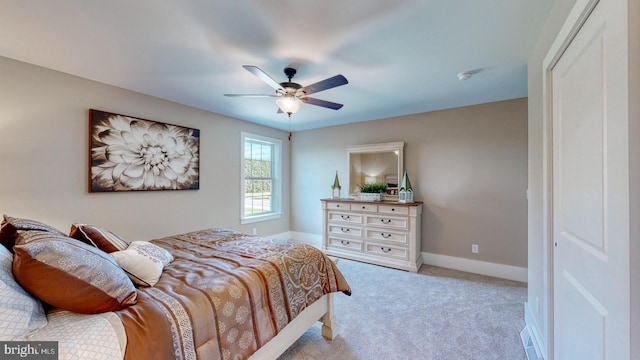 carpeted bedroom featuring ceiling fan and a closet