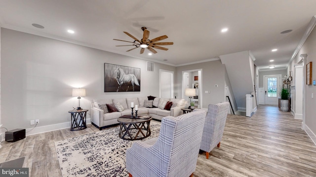 living room featuring light hardwood / wood-style flooring, ceiling fan, and crown molding