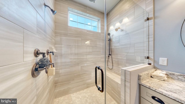 bathroom featuring vanity and an enclosed shower