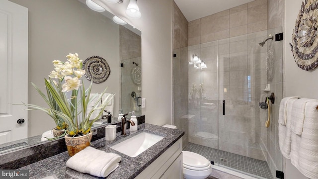 bathroom featuring vanity, toilet, and walk in shower