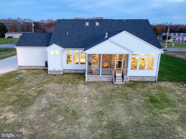 rear view of house with a lawn