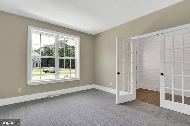 unfurnished room with carpet floors and french doors