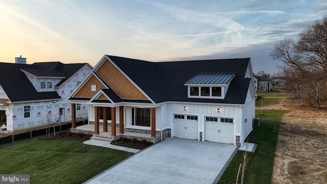 view of front facade with a yard and a garage