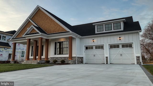 view of front of property featuring a porch and a garage