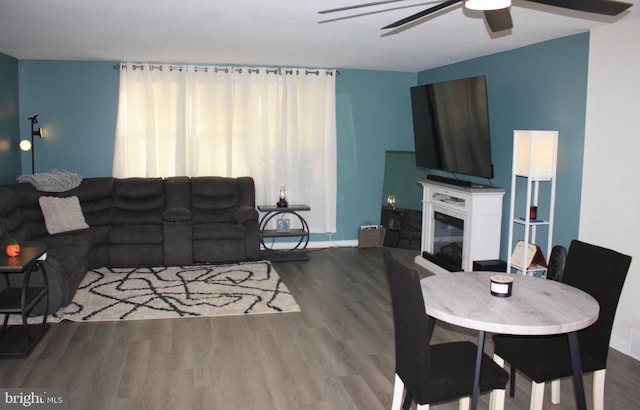 living room featuring hardwood / wood-style flooring and ceiling fan