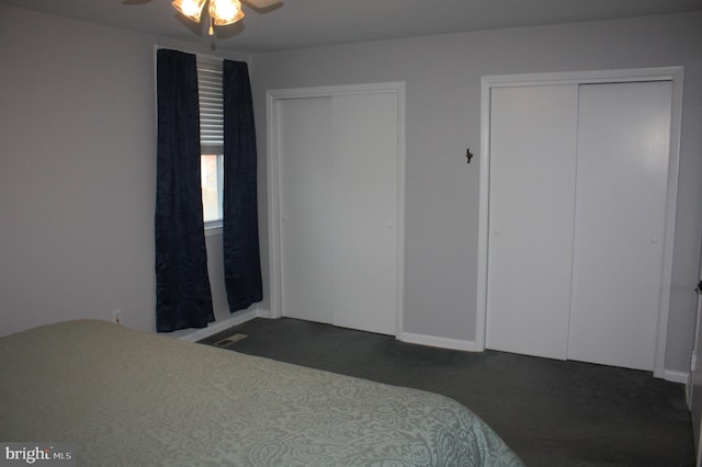 bedroom featuring ceiling fan and multiple closets