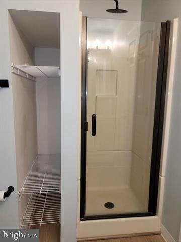 bathroom with a shower with door