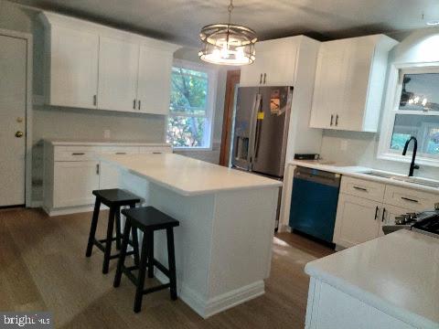 kitchen featuring white cabinetry, dishwasher, and sink