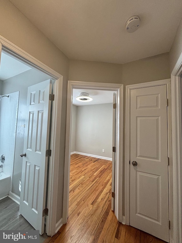 corridor with light wood-type flooring