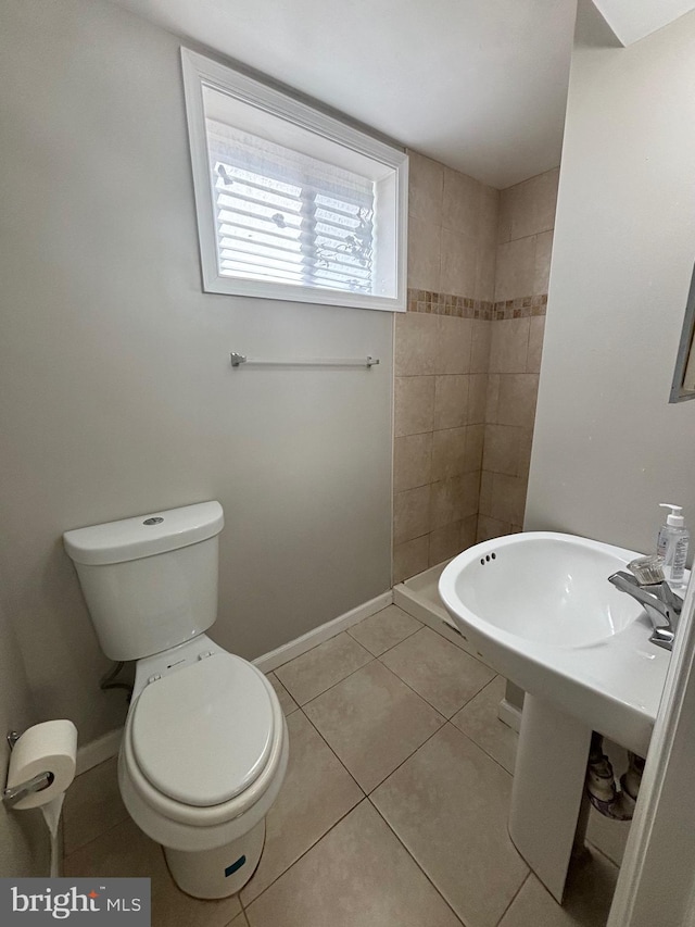 bathroom featuring toilet and tile patterned floors