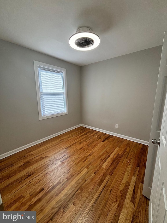 empty room with hardwood / wood-style floors