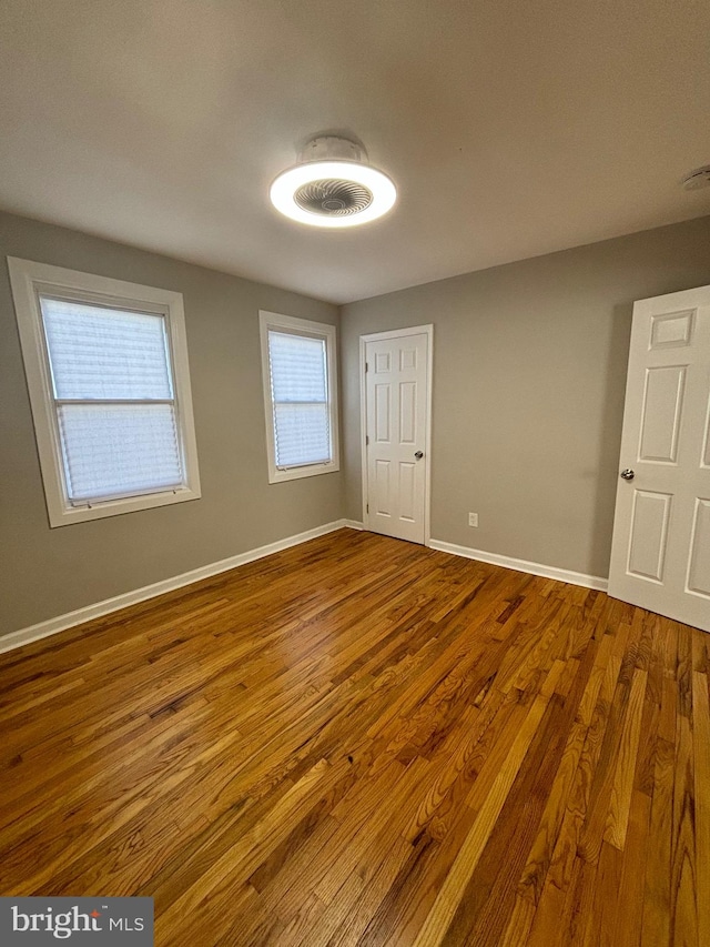 unfurnished room with wood-type flooring