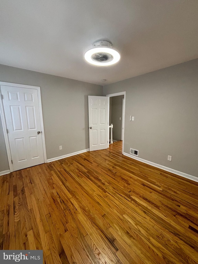 unfurnished room featuring hardwood / wood-style flooring