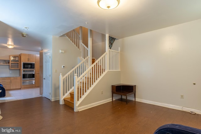 stairway with hardwood / wood-style flooring