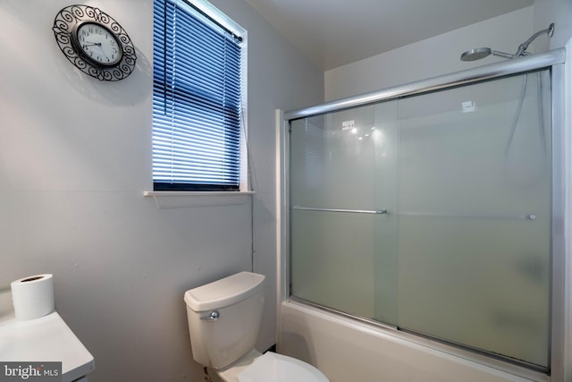 full bathroom with vanity, toilet, and combined bath / shower with glass door