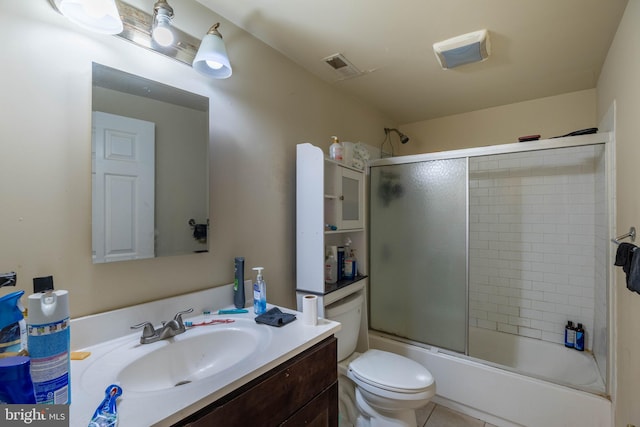 full bathroom with vanity, toilet, combined bath / shower with glass door, and tile patterned flooring