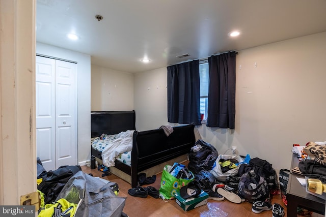 bedroom with a closet and hardwood / wood-style flooring