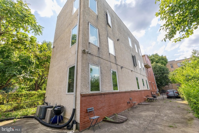 view of home's exterior featuring a patio area and central AC unit