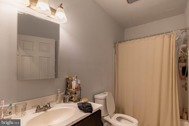 bathroom featuring vanity, toilet, and walk in shower