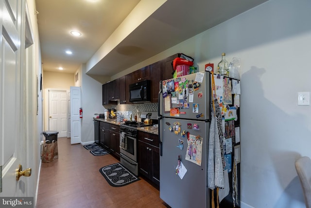 kitchen with backsplash, stainless steel appliances, dark brown cabinets, and hardwood / wood-style floors