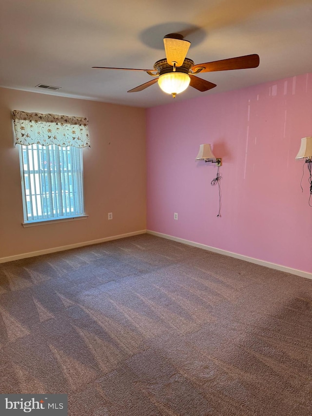 unfurnished room featuring ceiling fan and carpet