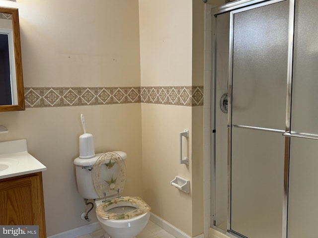 bathroom with vanity, tile patterned floors, toilet, and walk in shower