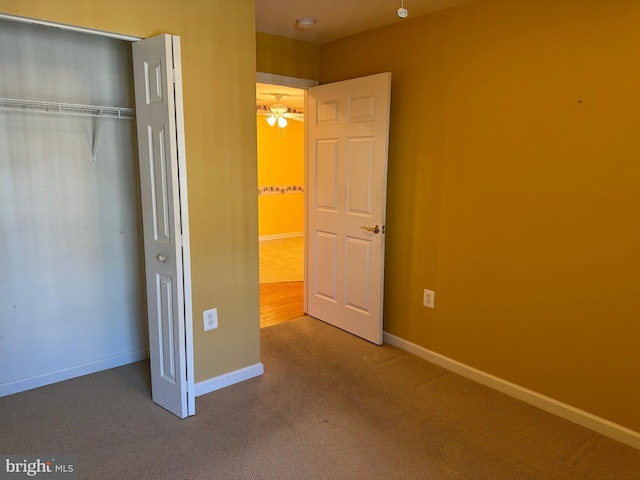 unfurnished bedroom featuring a closet and carpet floors