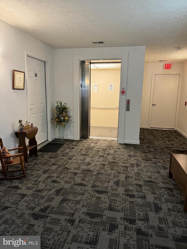 hallway with a textured ceiling