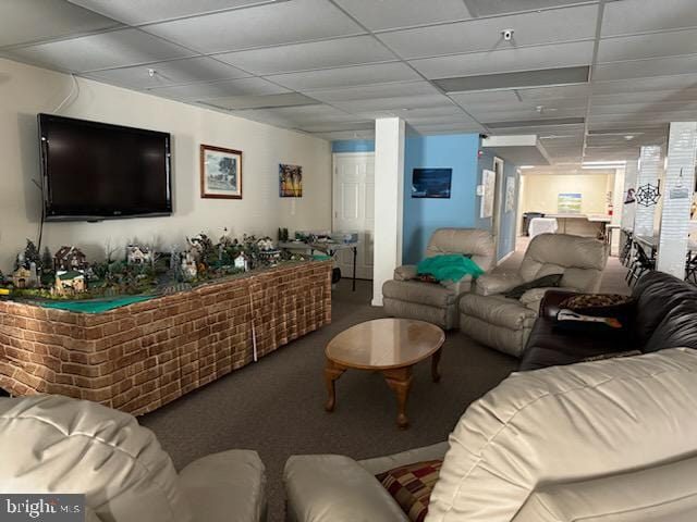 carpeted living room with a drop ceiling