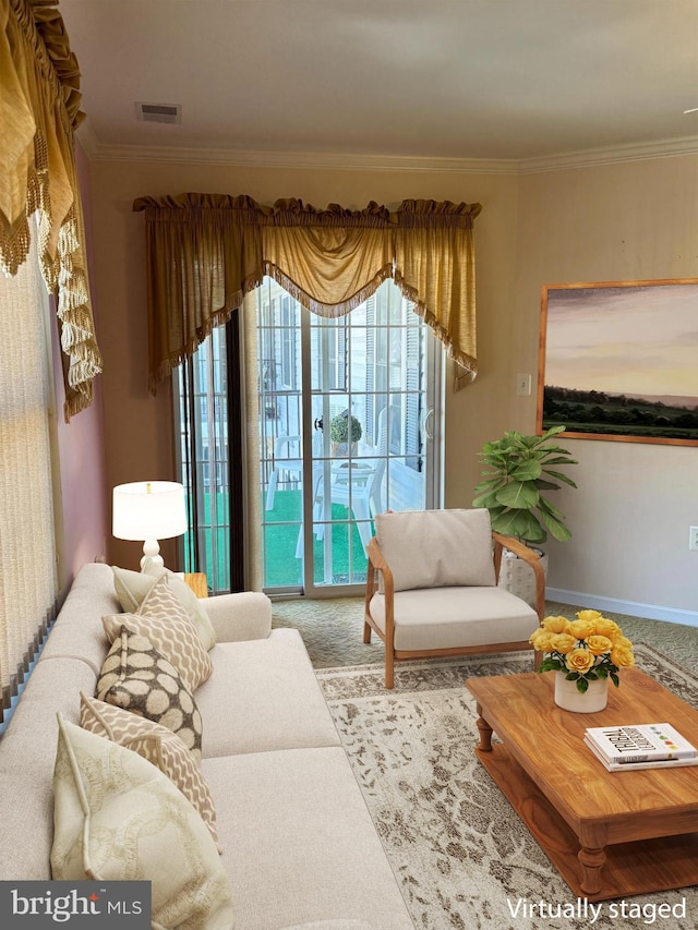 living area with ornamental molding, carpet, and plenty of natural light