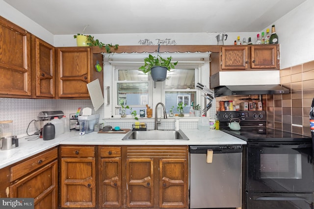 kitchen with sink, decorative backsplash, wall chimney range hood, and stainless steel appliances