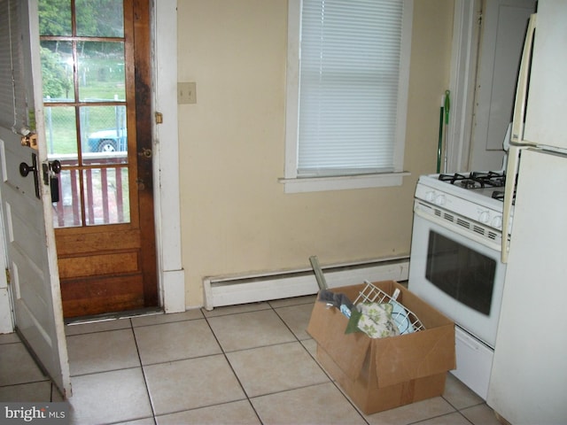 kitchen with white cabinets, white appliances, a baseboard radiator, and light tile patterned flooring