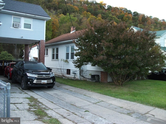 view of side of property with a lawn