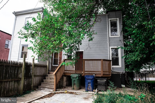 back of property with a wooden deck