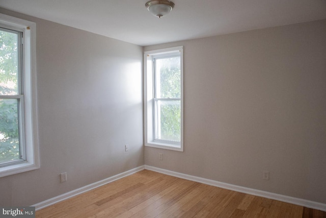 spare room with light wood-type flooring