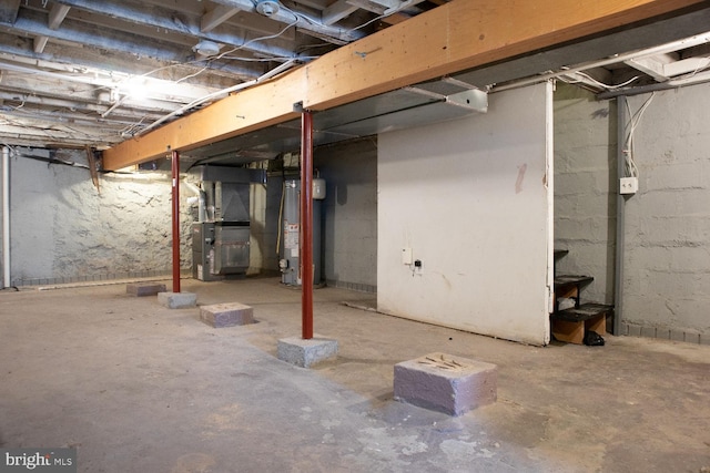 basement featuring water heater and heating unit