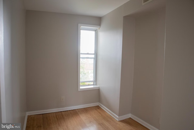 unfurnished room with light wood-type flooring