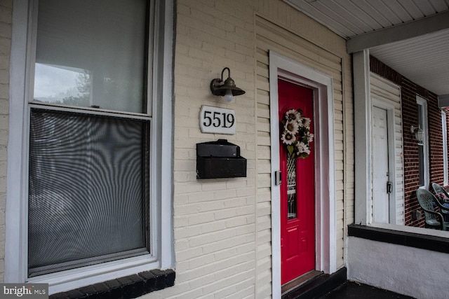 view of exterior entry with covered porch