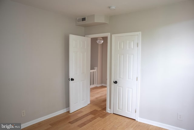 unfurnished bedroom with light wood-type flooring