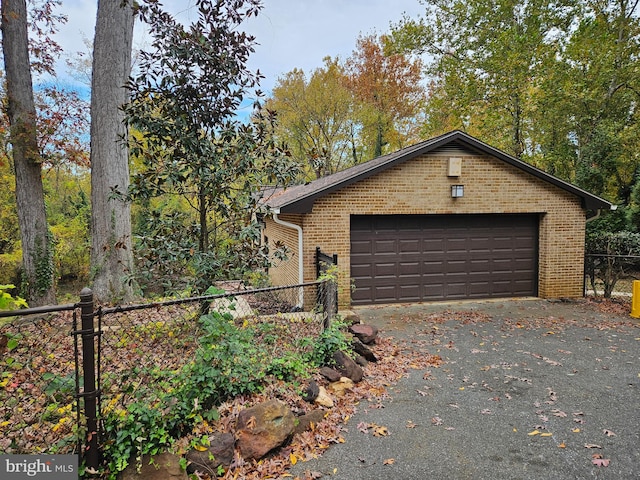 view of side of home with an outdoor structure and a garage