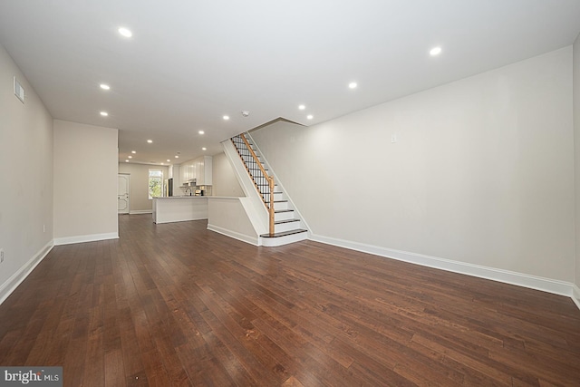 unfurnished living room featuring dark hardwood / wood-style flooring