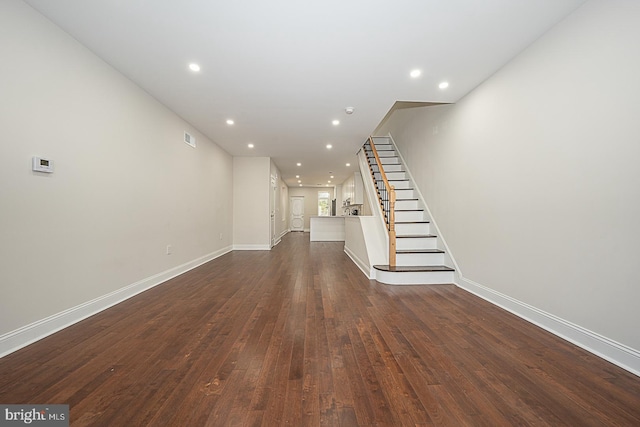 unfurnished living room featuring dark hardwood / wood-style flooring